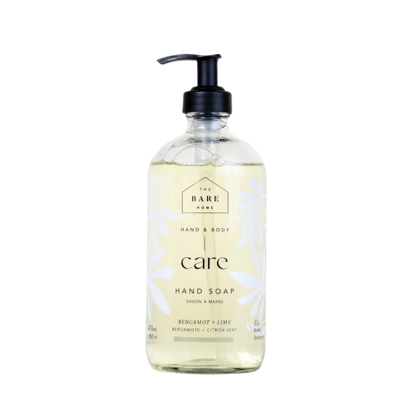 A clear glass pump bottle of The Bare Home Hand Soap with Bergamot & Lime label, indicating it is a refillable product.