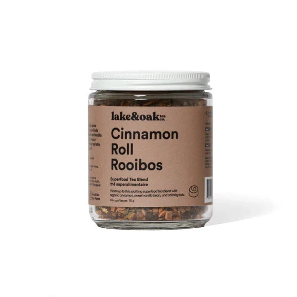 A glass jar containing Lake & Oak Cinnamon Roll Rooibos tea, with a label displaying the product name and organic certification.