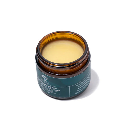 An open jar of the 'Dave in the City' nourishing beard balm, showing the balm-like consistency of the product on a white background.