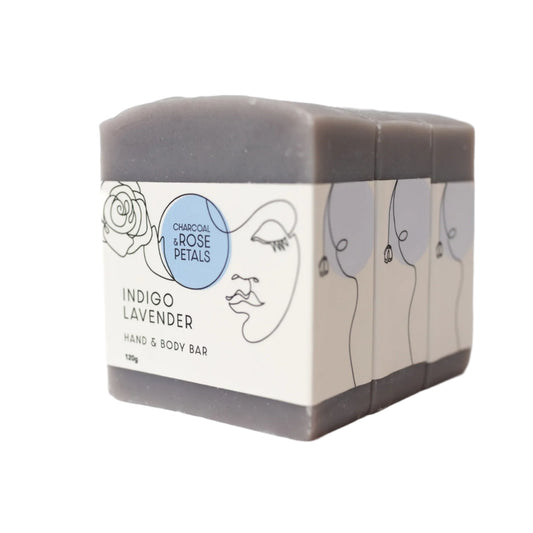 Charcoal & Rose Petals Indigo Lavender hand and body bar with branding on a white background.