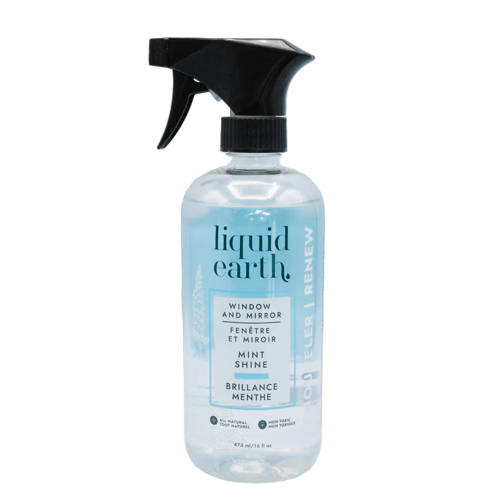Bottle of Liquid Earth window and mirror cleaner on a light blue background
