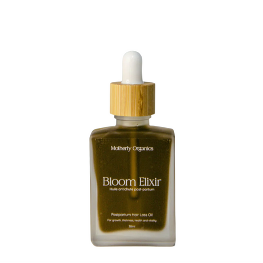Glass bottle of Motherly Organics 'Bloom Elixir' postpartum hair loss oil with a dropper on a light grey background.