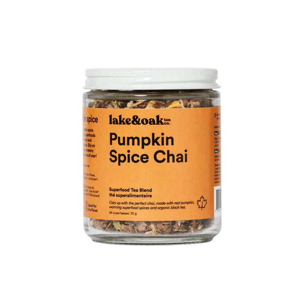 A glass jar of Lake & Oak Tea pumpkin spice chai superfood tea blend. It has an orange label and is sitting on a white background.