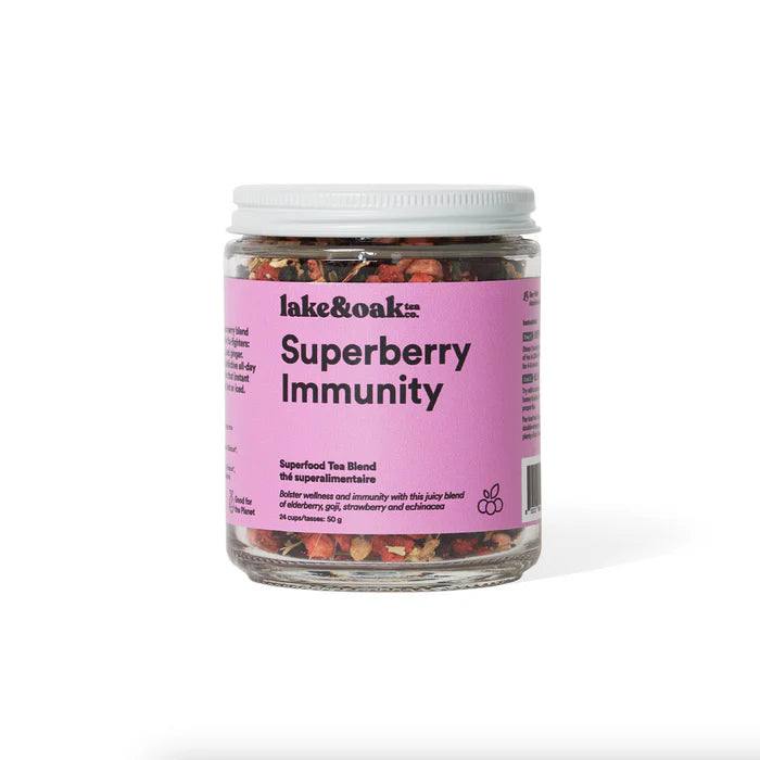 A glass jar of Lake & Oak Tea superberry immunity superfood tea blend. It has a pink label and is sitting on a white background.