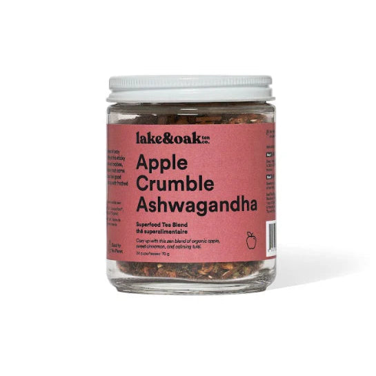 A glass jar of Lake & Oak Tea apple crumble ashwagandha superfood tea blend. It has a red label and is sitting on a white background.